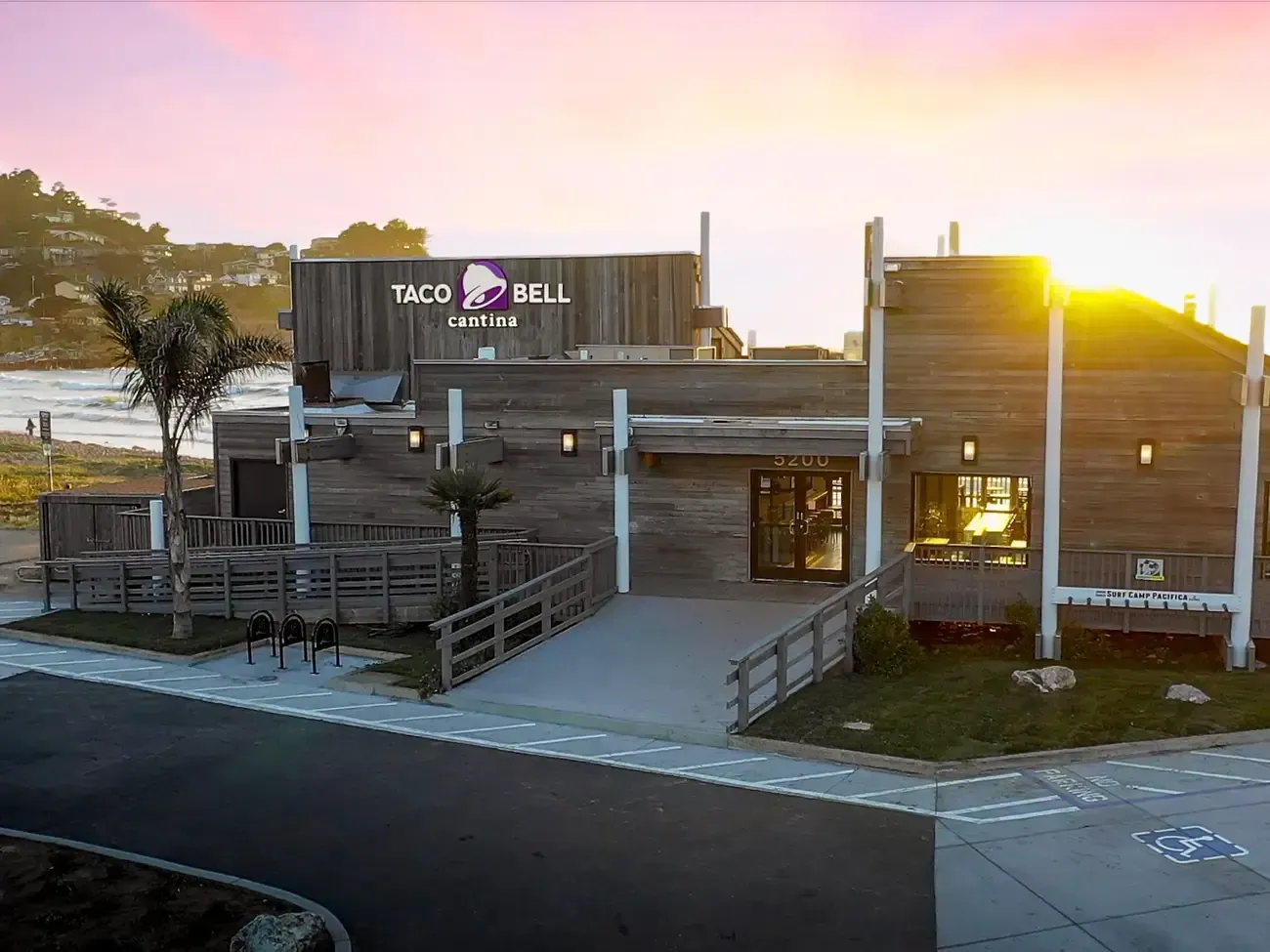 An aerial view of a taco bell restaurant at sunset.