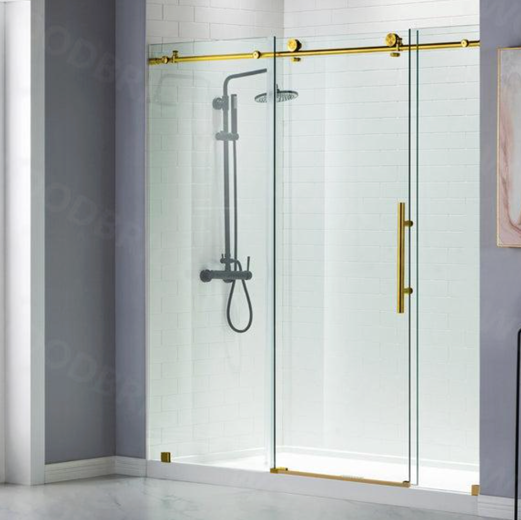 Modern glass shower enclosure with gold trim and a wall-mounted showerhead in a white bathroom