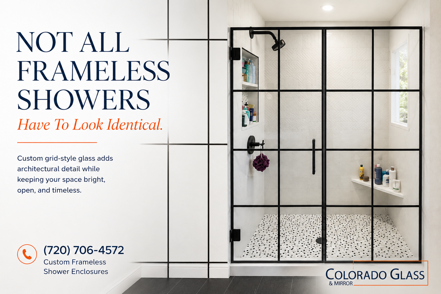 Glass shower enclosure with stone tile walls and a black handle.