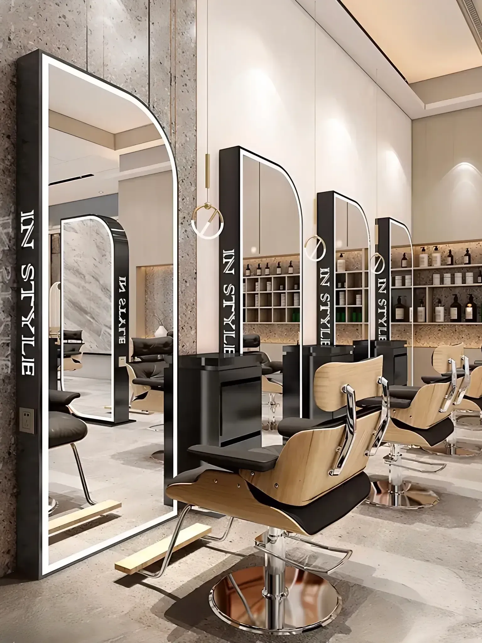 Salon interior: arched mirrors with lights, black and tan chairs, shelves of products.