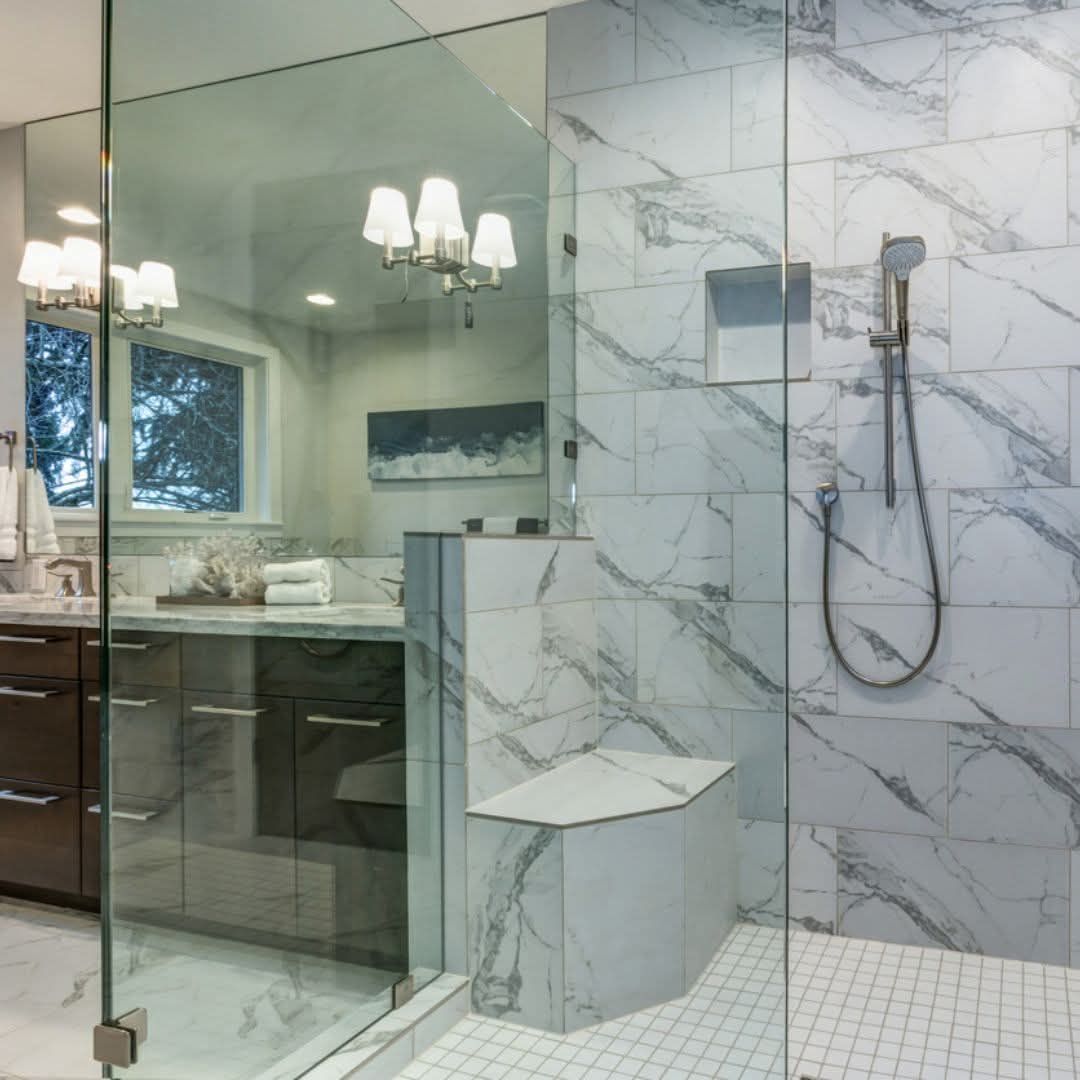 Frameless glass Shower Enclosure With a Half-Wall and Built-in Bench