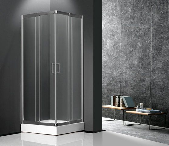 A modern square shower enclosure with glass doors and silver frames, set in a contemporary bathroom with stone walls.