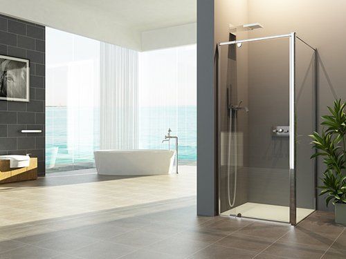 A modern bathroom features a glass walk-in shower, a freestanding white bathtub, and large windows with natural light.