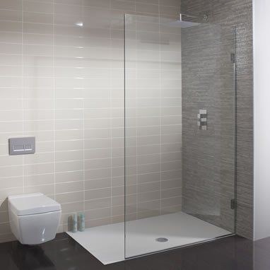 Modern bathroom with a wall-mounted toilet, a glass walk-in shower, and a white shower tray against gray tiled walls.