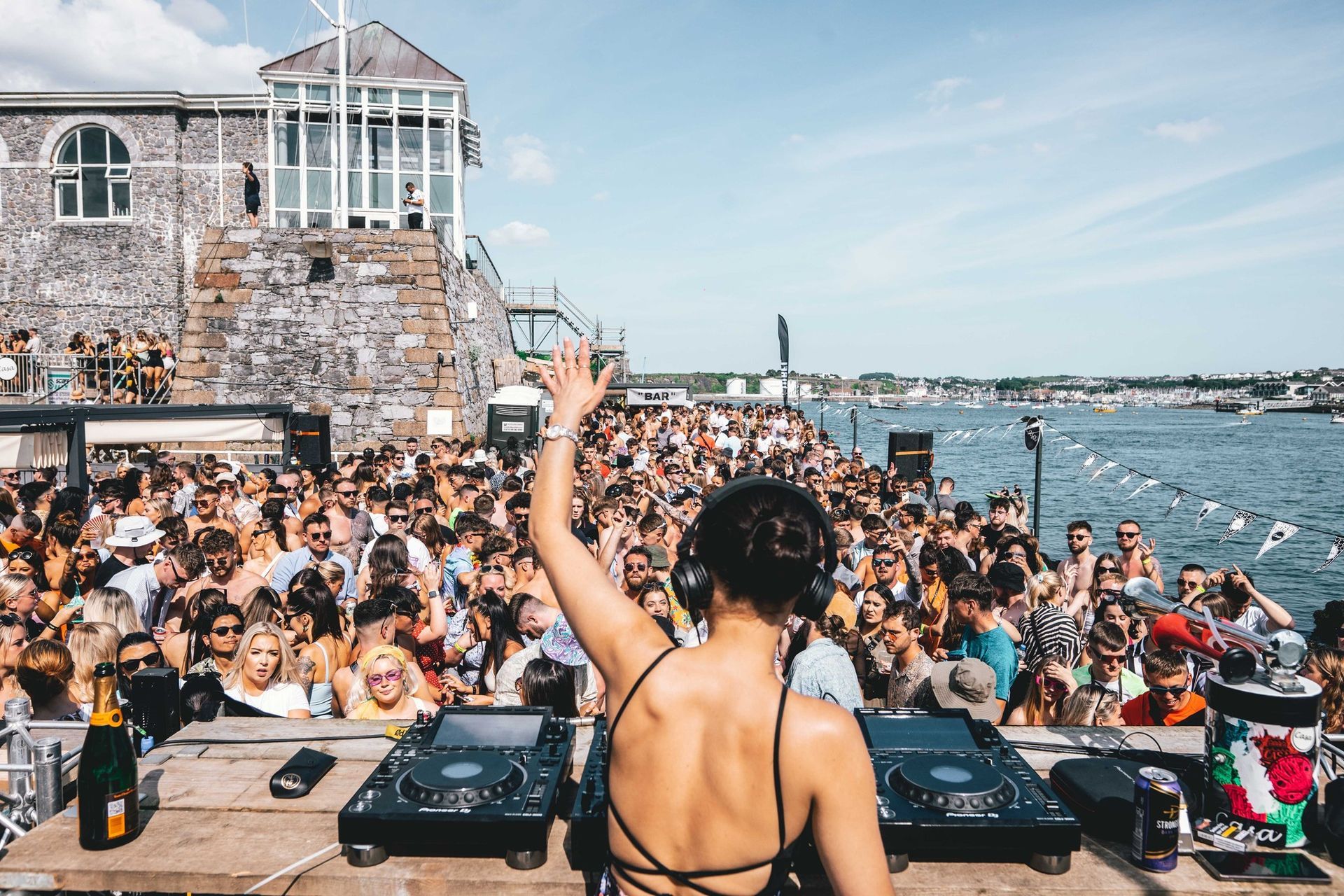 A woman is playing music in front of a crowd of people.