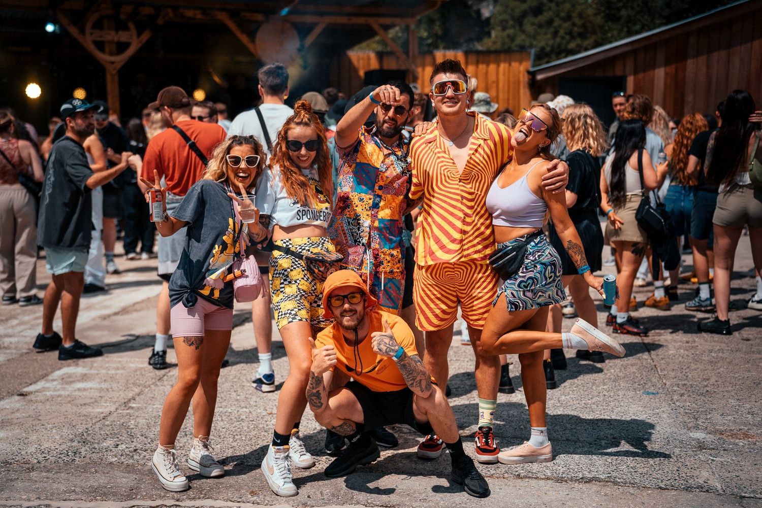 A group of people are posing for a picture at a festival.