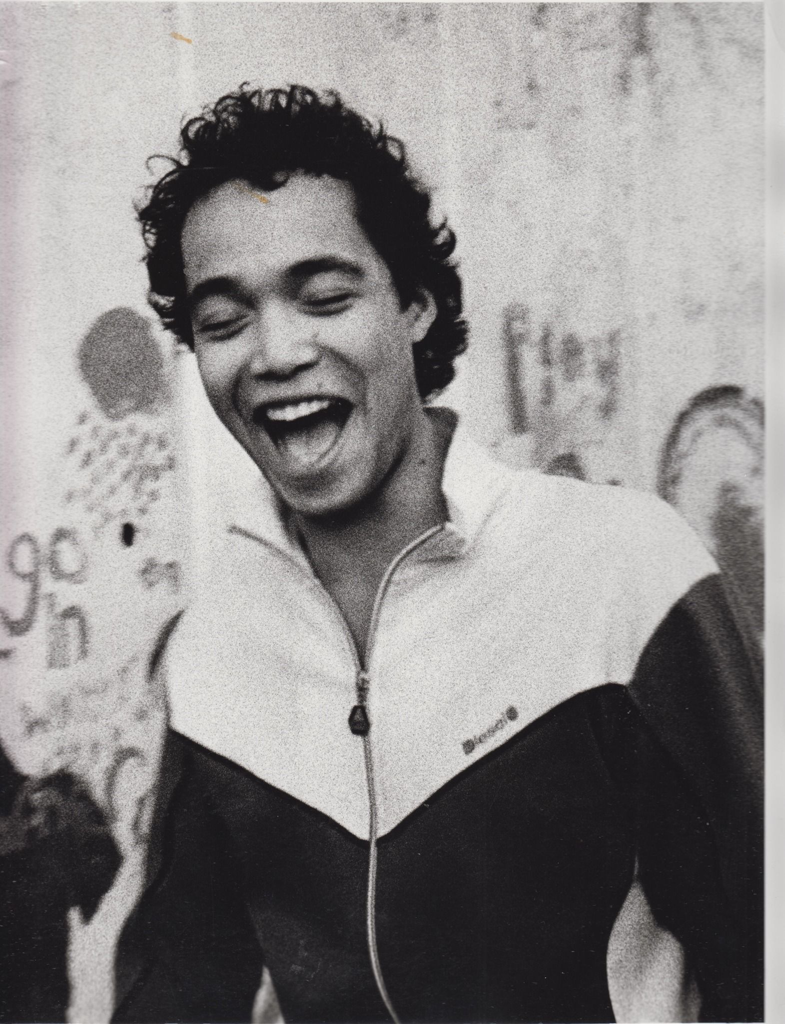 A black and white photo of a man wearing a reebok jacket