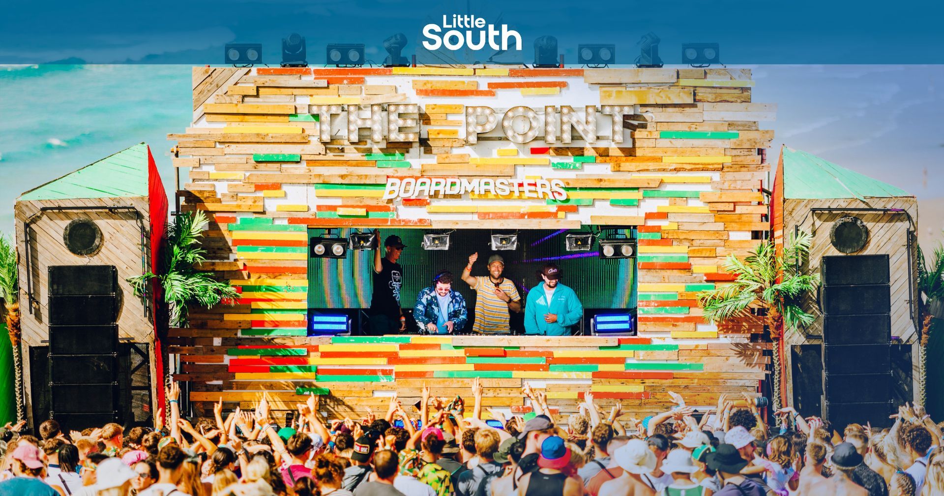 A large crowd of people are gathered in front of a stage that says the point