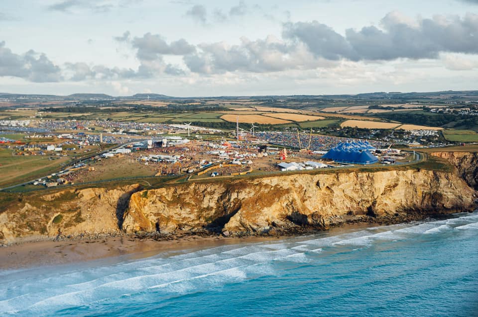 An aerial view of a city on a cliff overlooking the ocean.