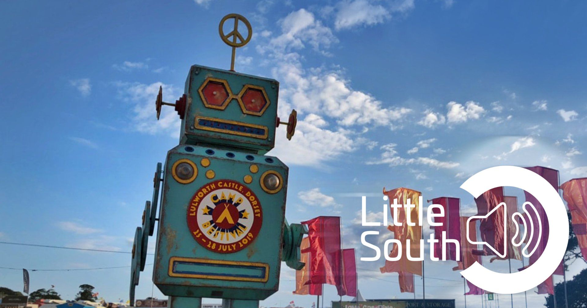 A statue of a robot with a peace sign on top of it.
