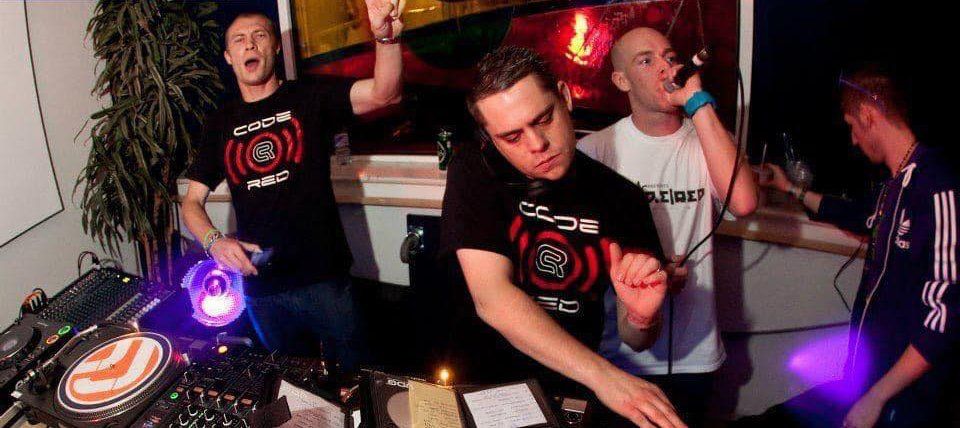 A group of men are standing around a table playing music
