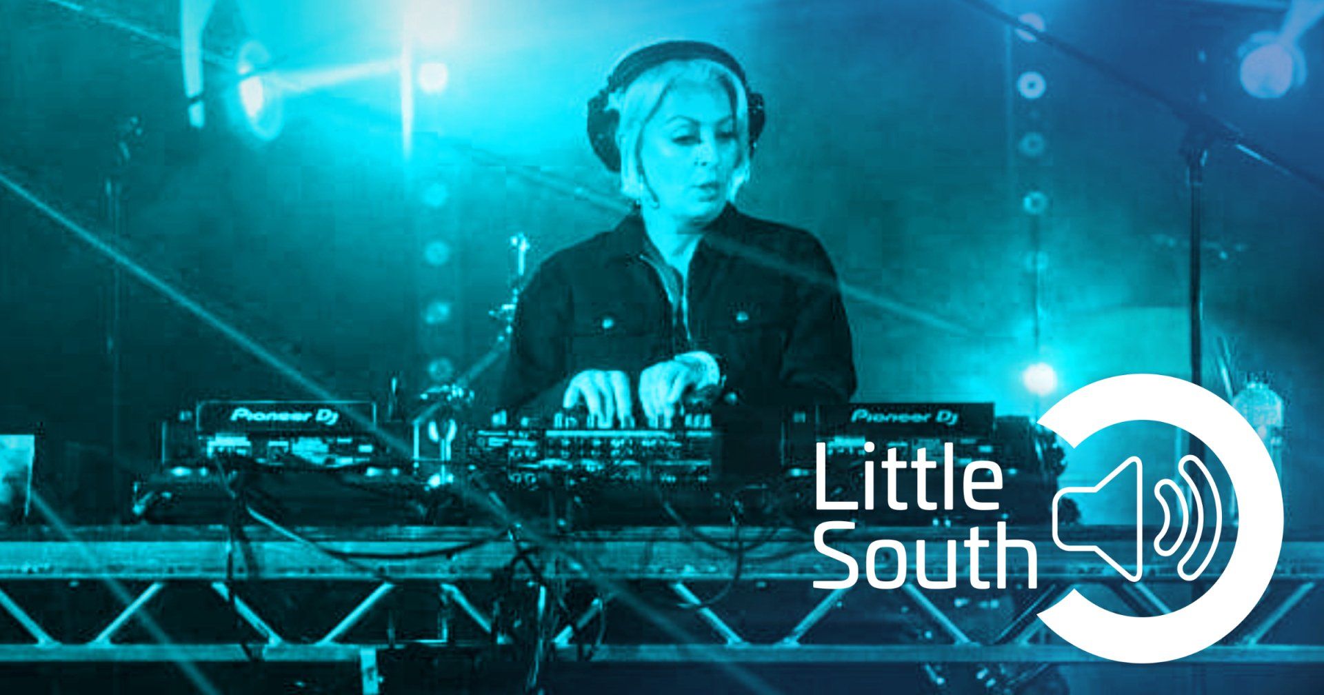 A woman wearing headphones is playing a dj set on a stage.