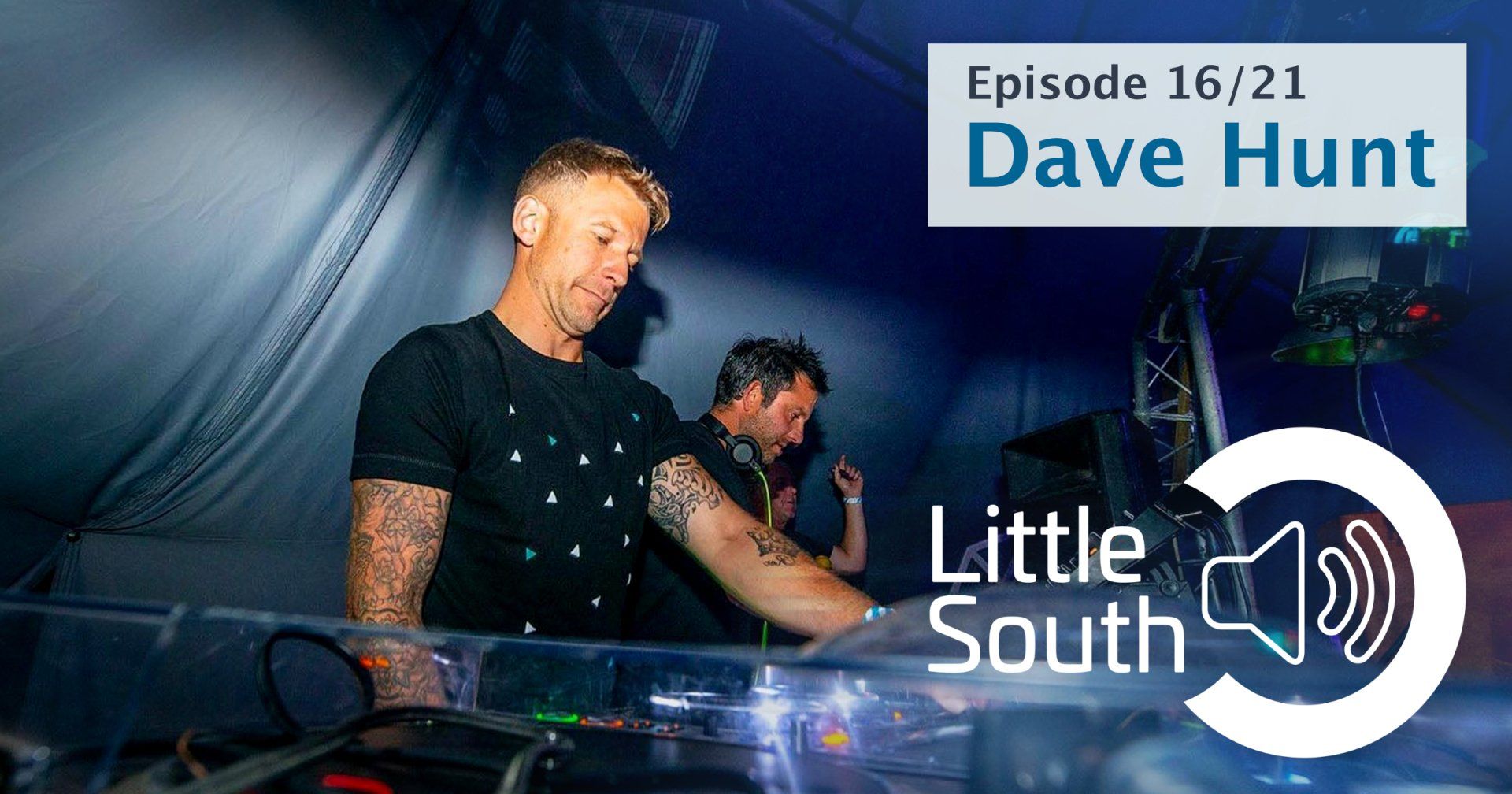 A man is playing a dj set in a dark room.