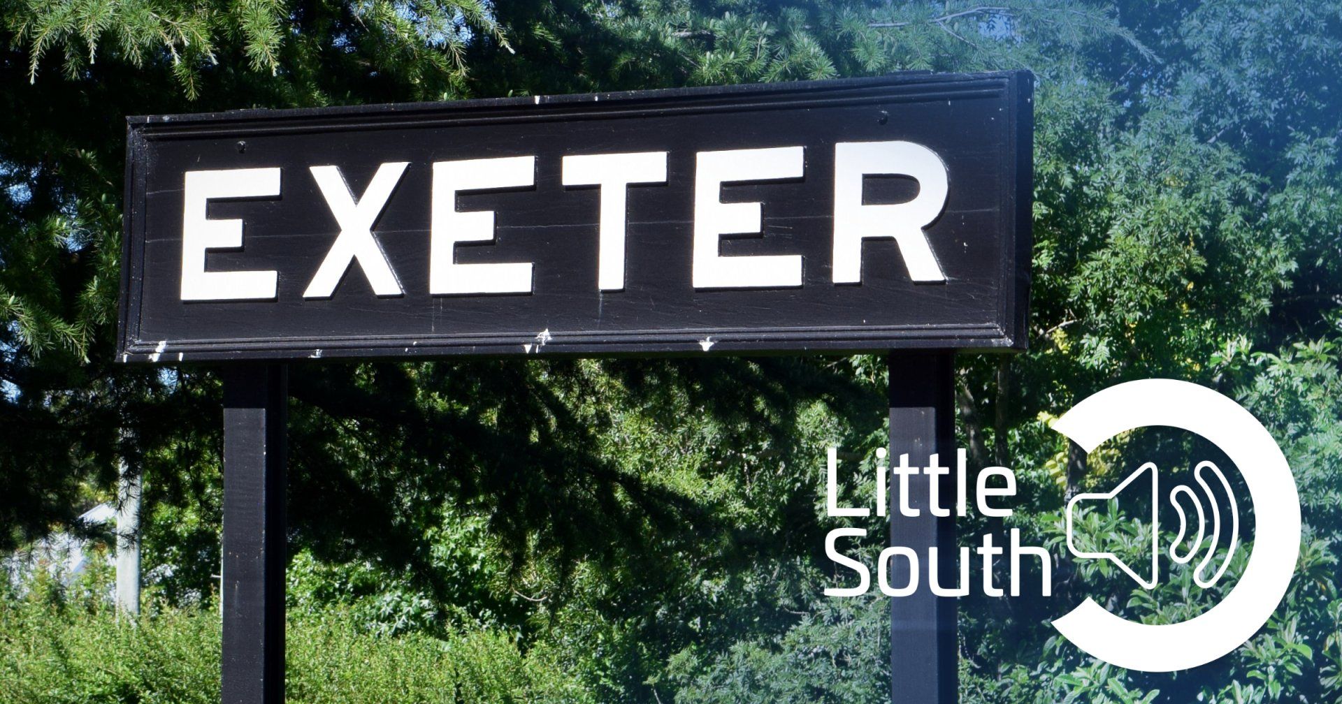 A black sign that says exeter in white letters