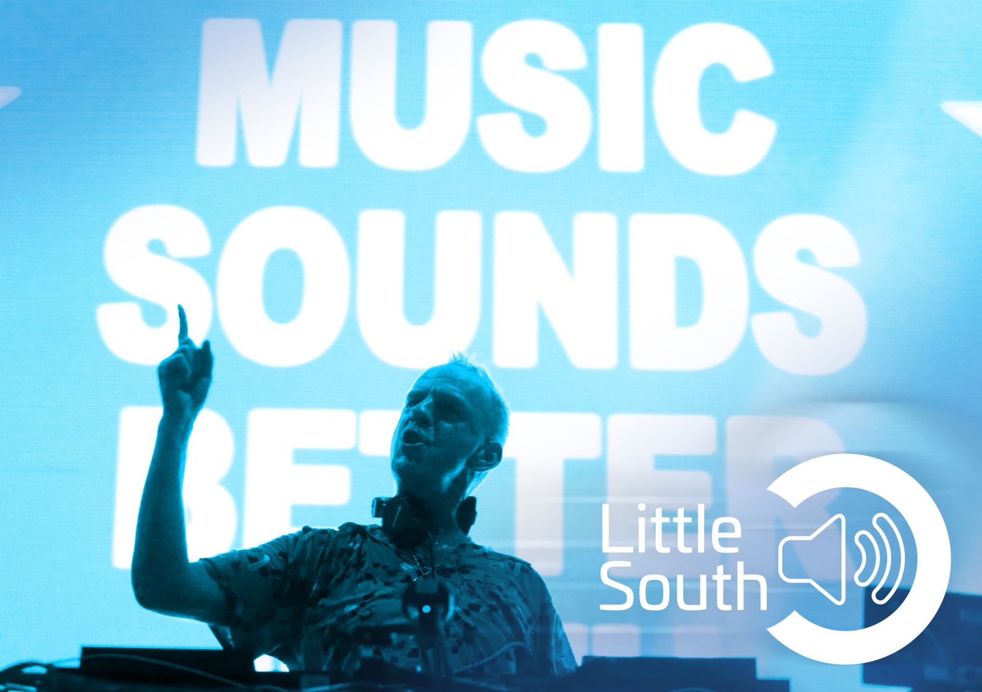 A man in front of a sign that says music sounds better