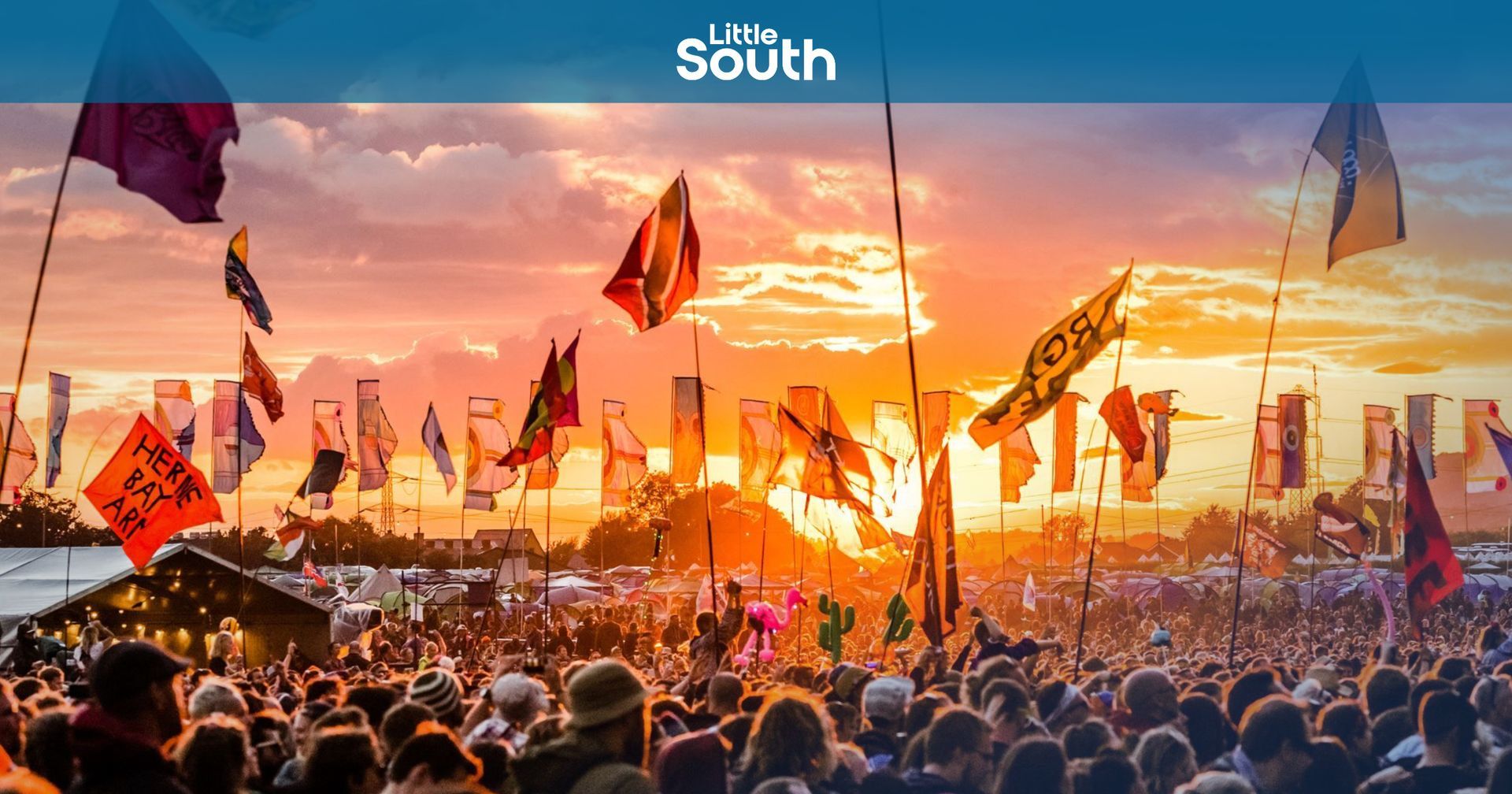 A large crowd of people are gathered at a music festival.
