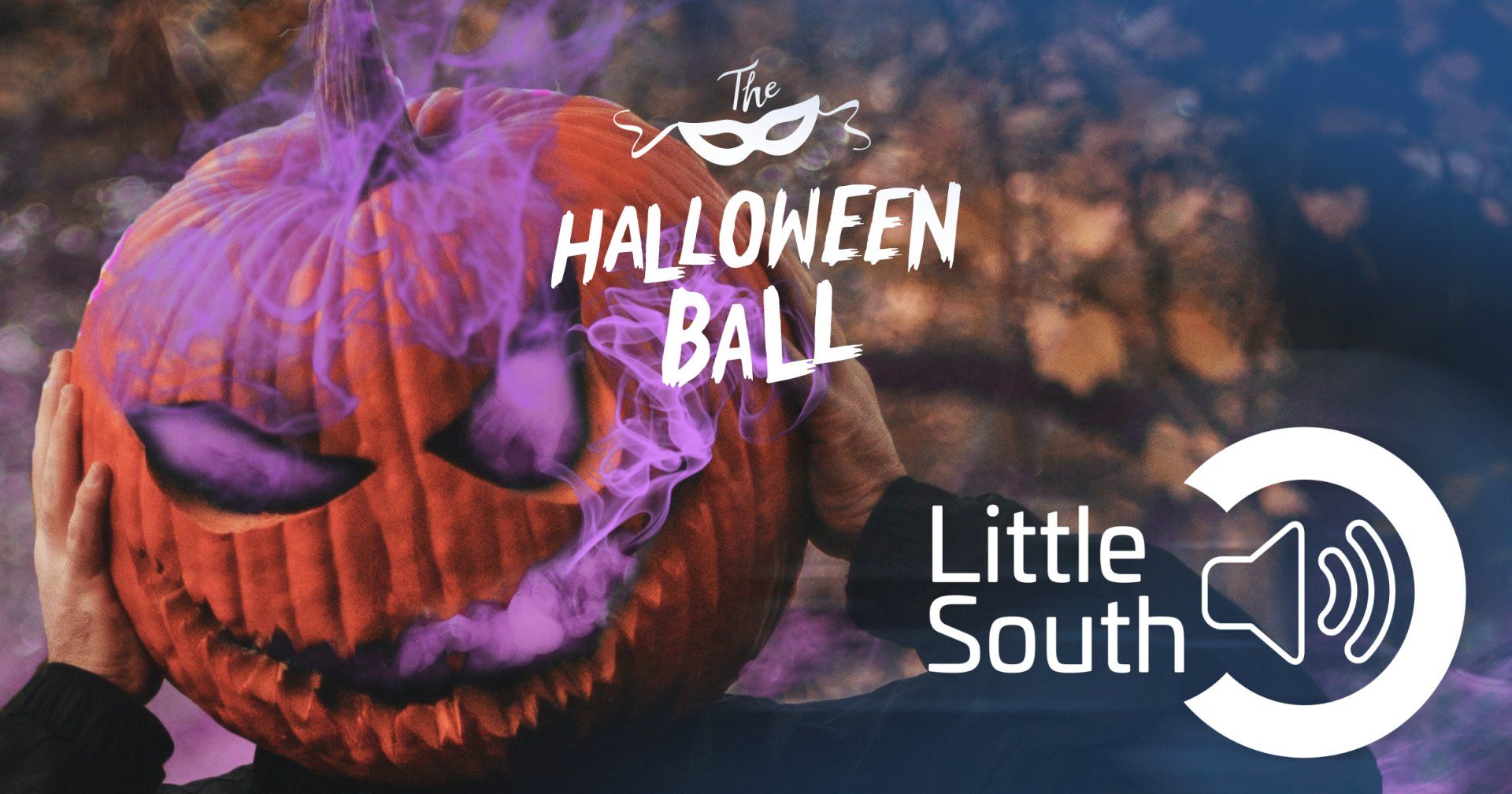 A person is holding a halloween pumpkin with purple smoke coming out of it.