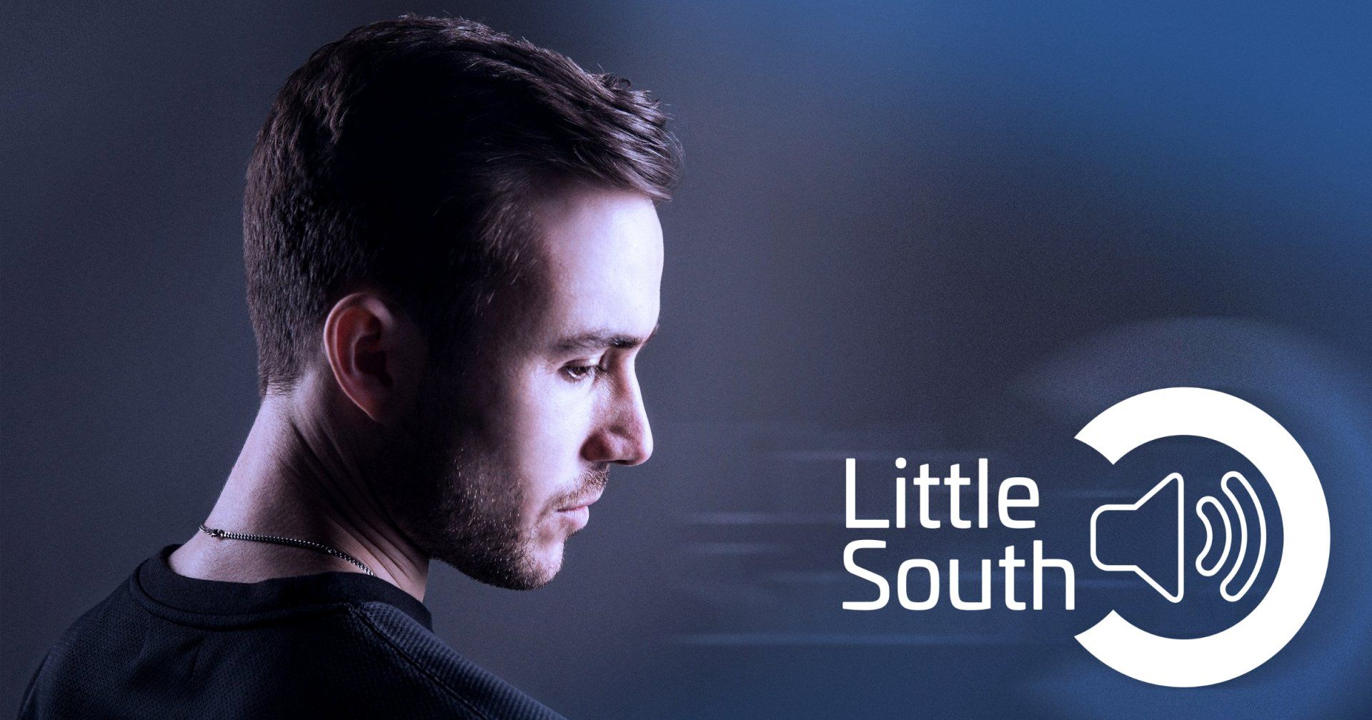 A man is standing in front of a little south logo