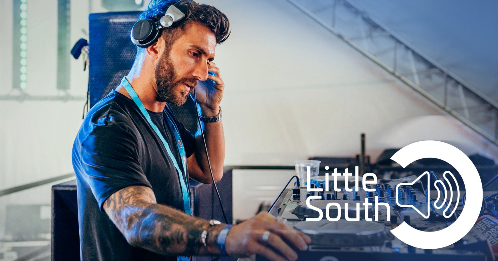 A man wearing headphones is playing music on a turntable.