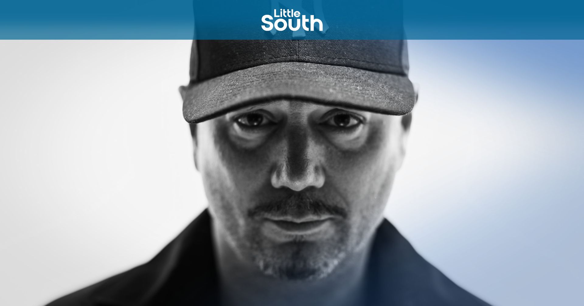 A man wearing a hat with the word south on it