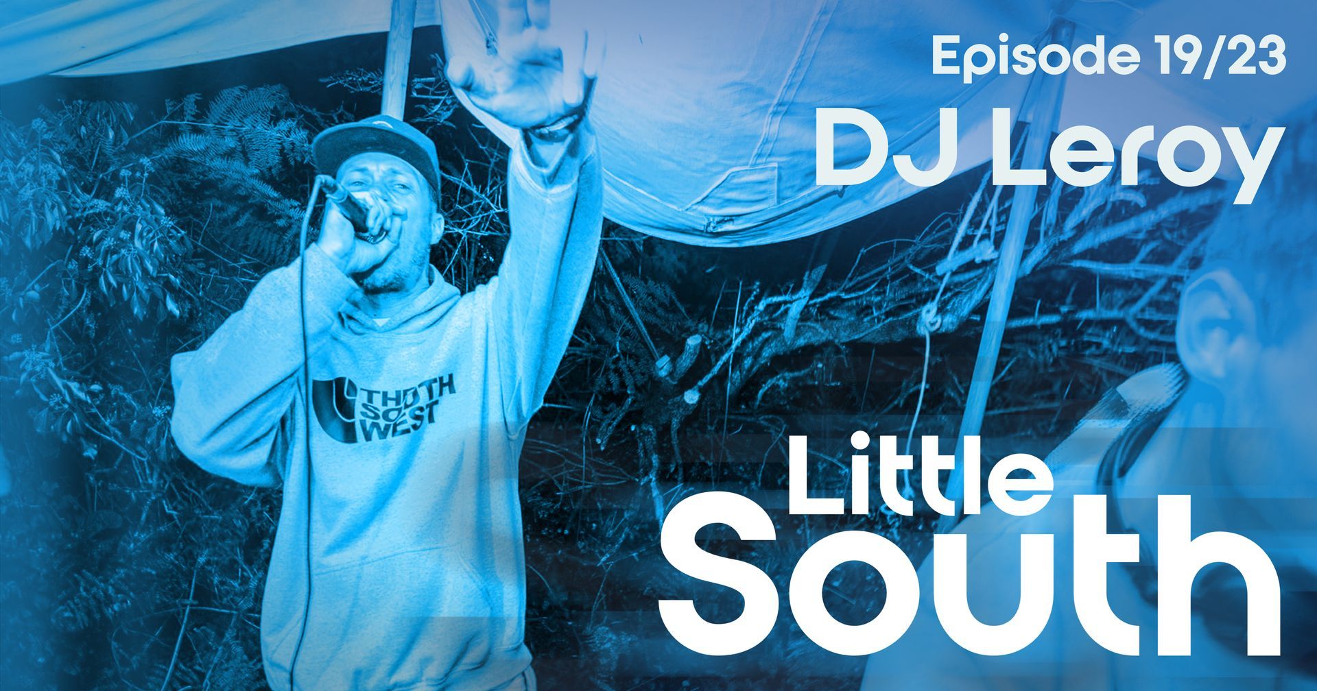 A man singing into a microphone with the words dj leroy little south below him