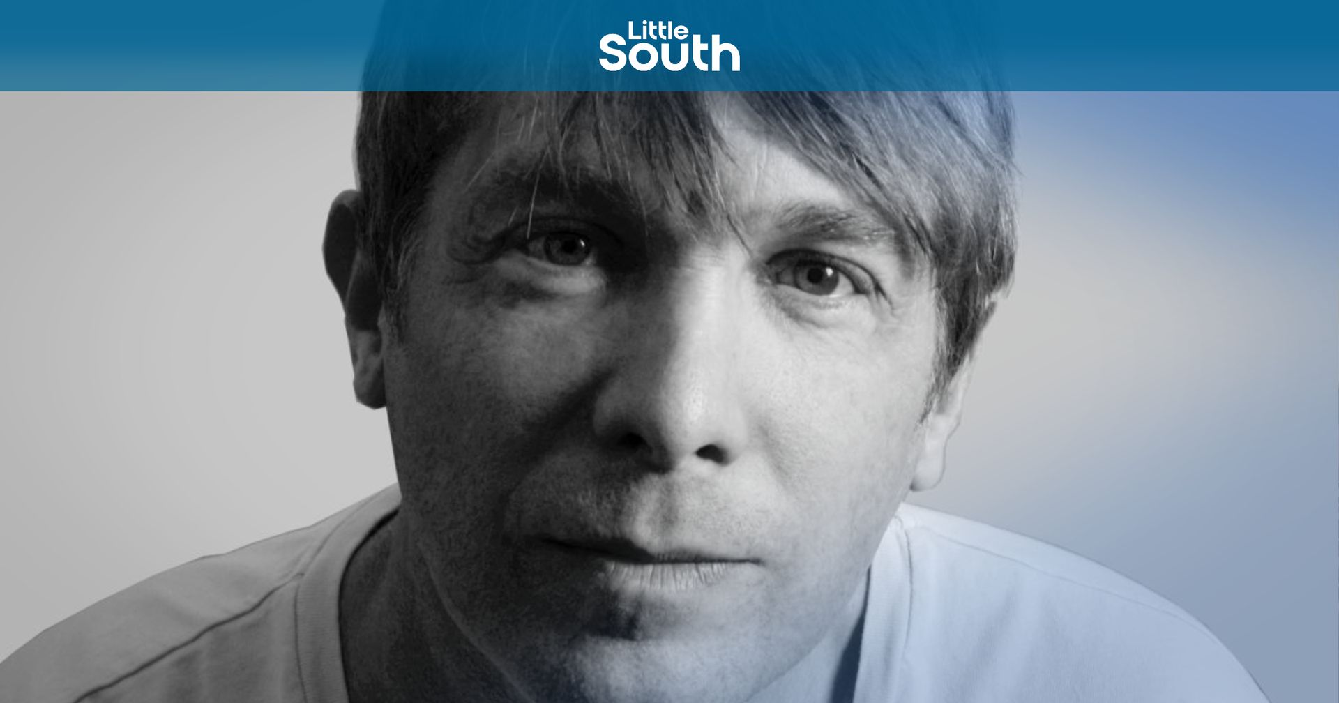 A man 's face is shown in a black and white photo.