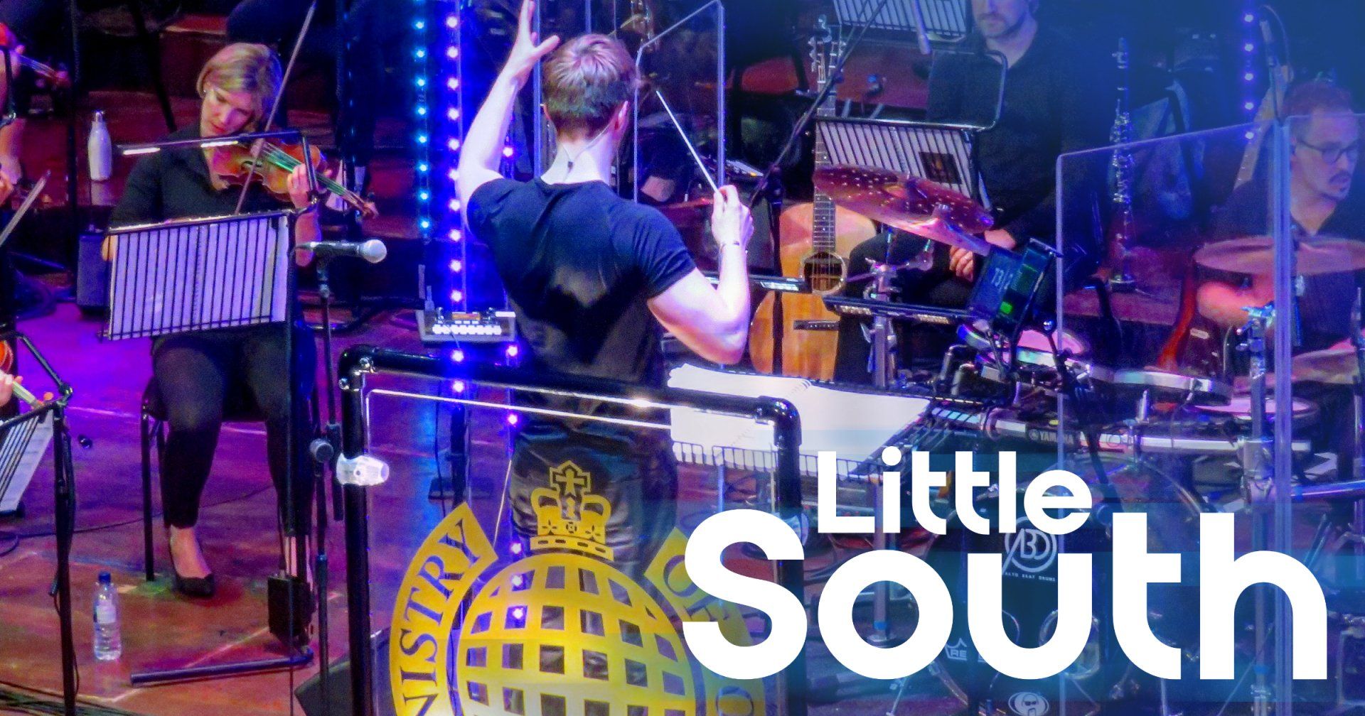 A group of people are playing instruments on a stage.