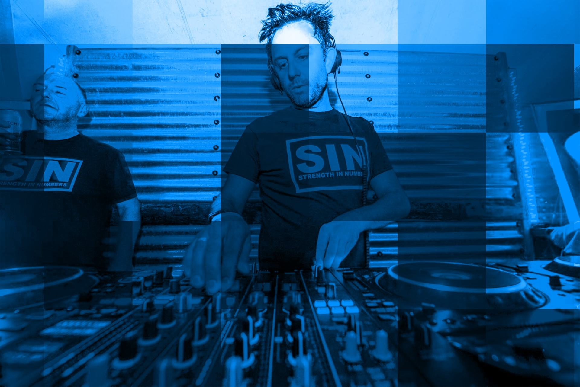 A man wearing a sin shirt is playing music