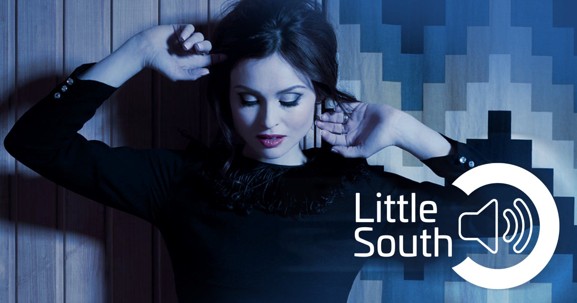A woman is standing in front of a sign that says little south