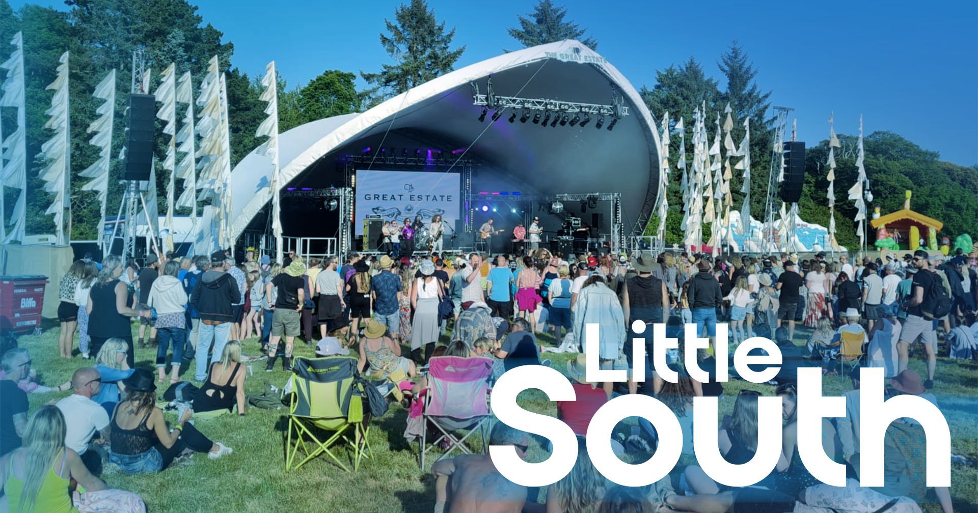 A large crowd of people are gathered at a little south festival