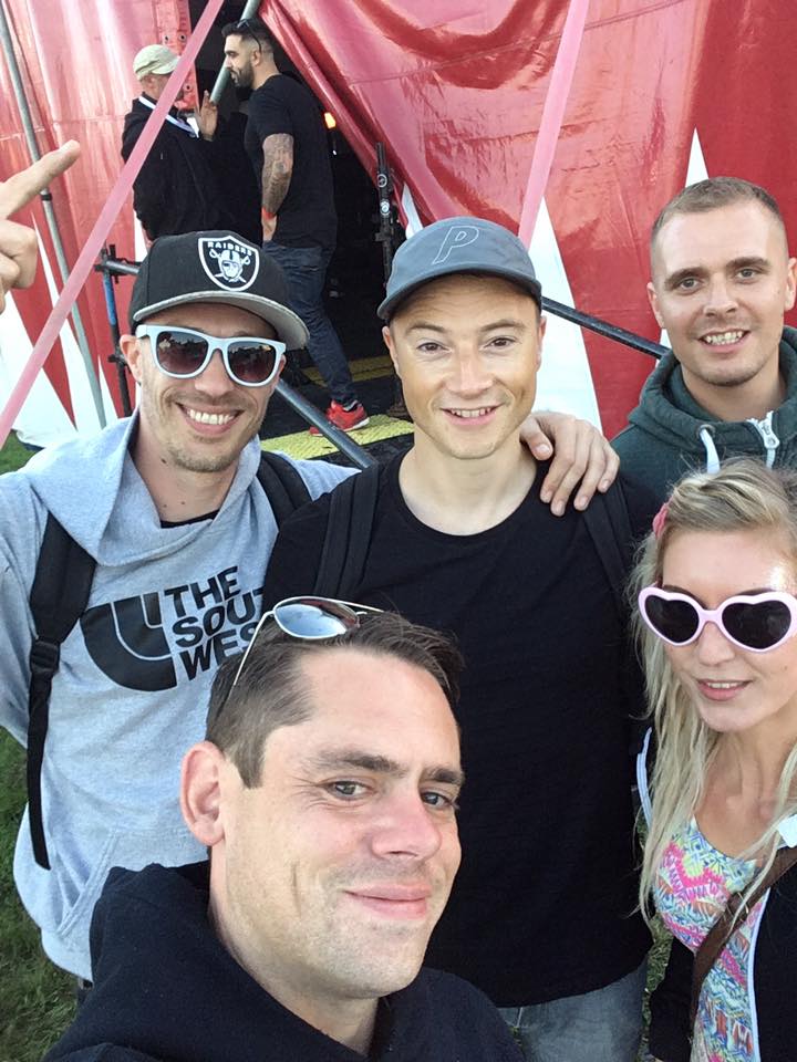 A group of people are posing for a picture in front of a tent.