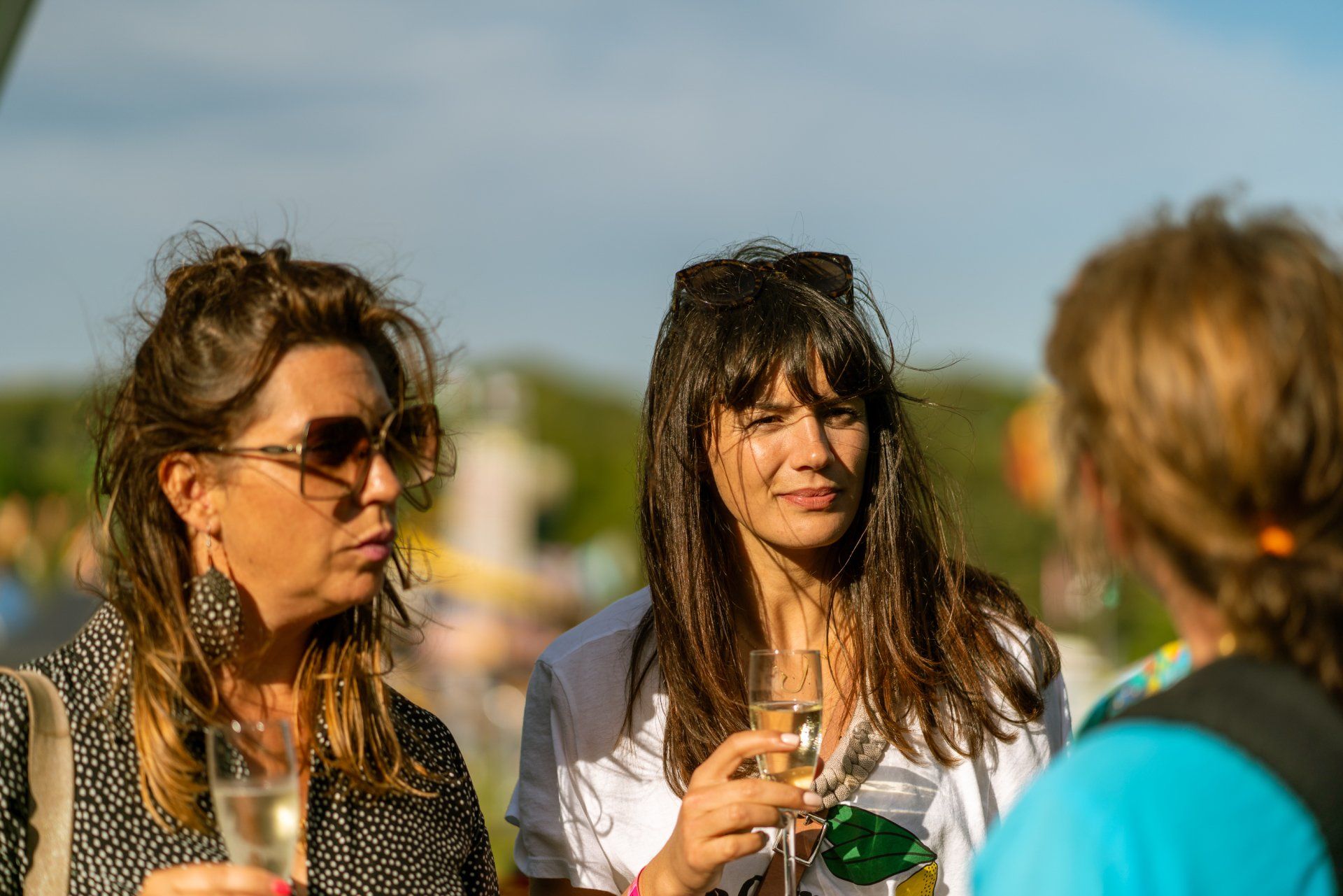 Two women are standing next to each other holding glasses of champagne.