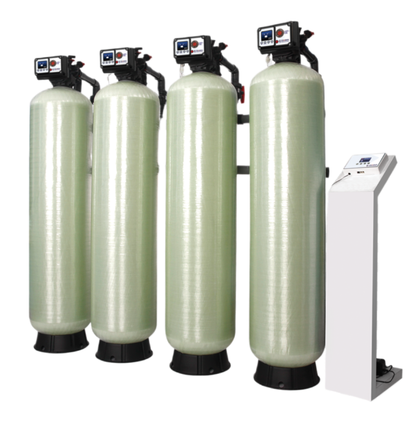 Four tall, light green water conditioner tanks with control panel