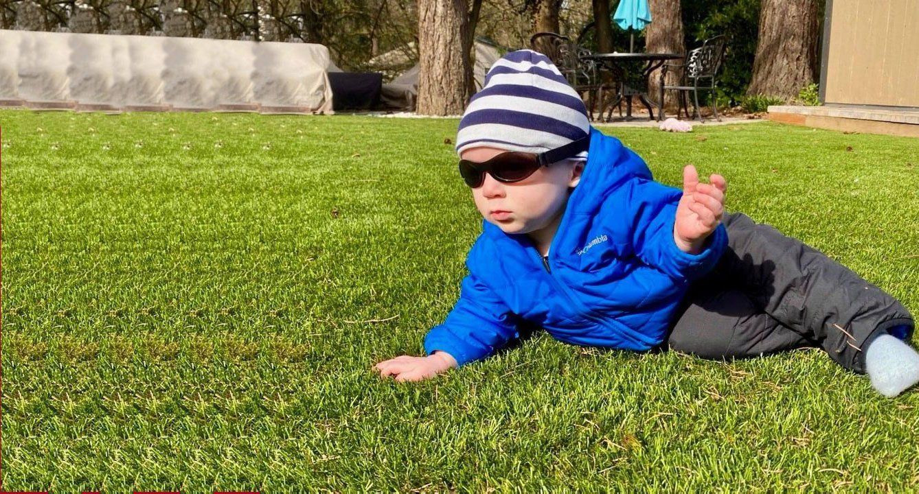 child lying on grass