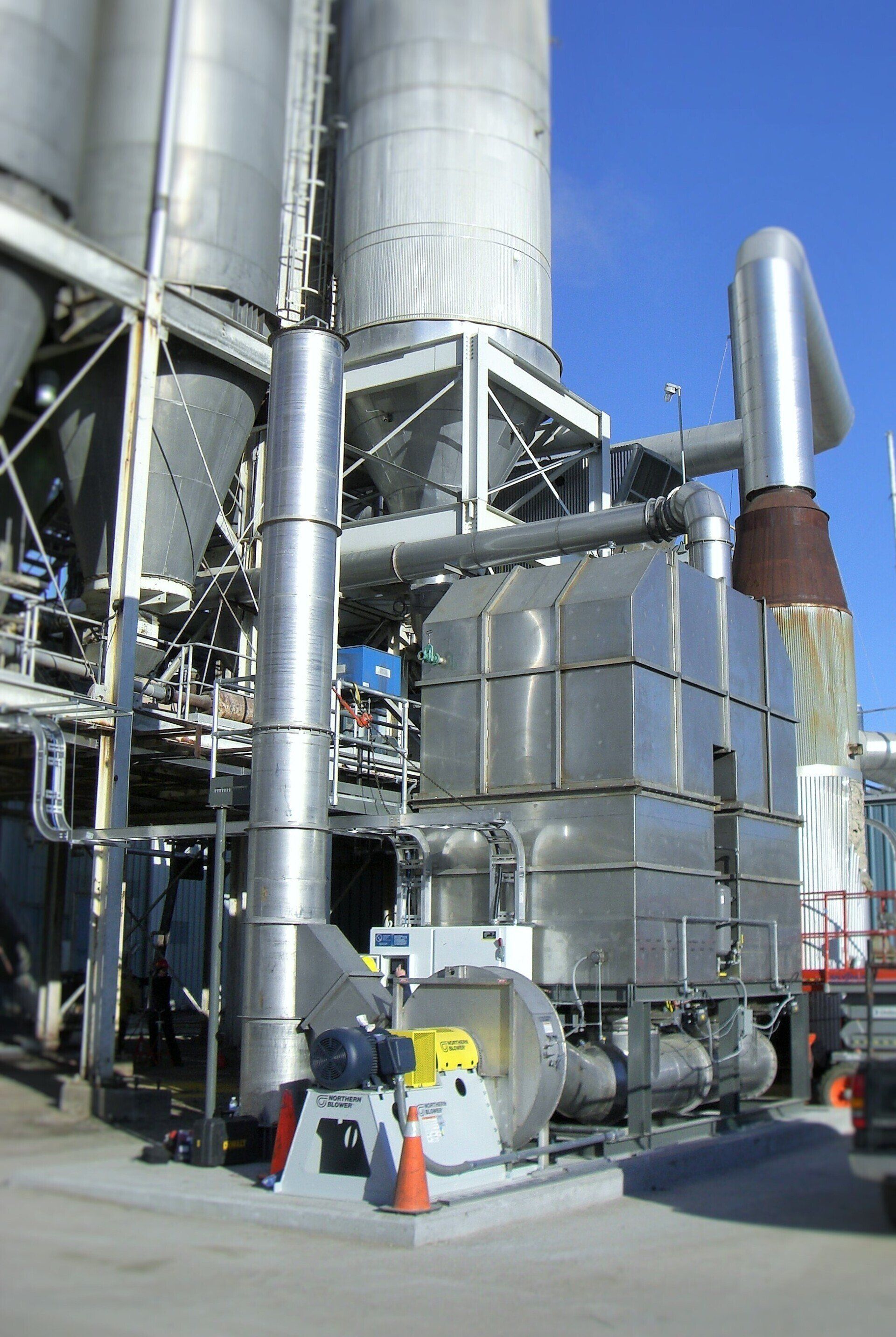 A factory with a lot of pipes and a fan