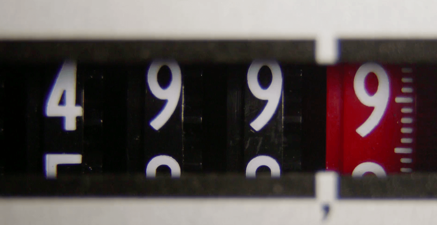 A close up of a measuring tape showing the numbers 4 and 9