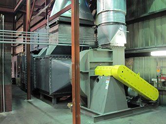 A large industrial fan with a yellow belt attached to it