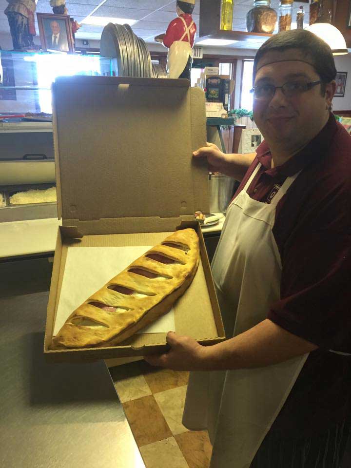 Man holding calzones — Mifflinburg, Pa — The Original Italian Pizza & Restaurant