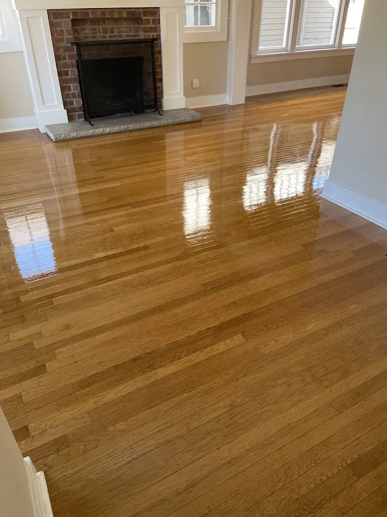 A living room with hardwood floors and a fireplace.