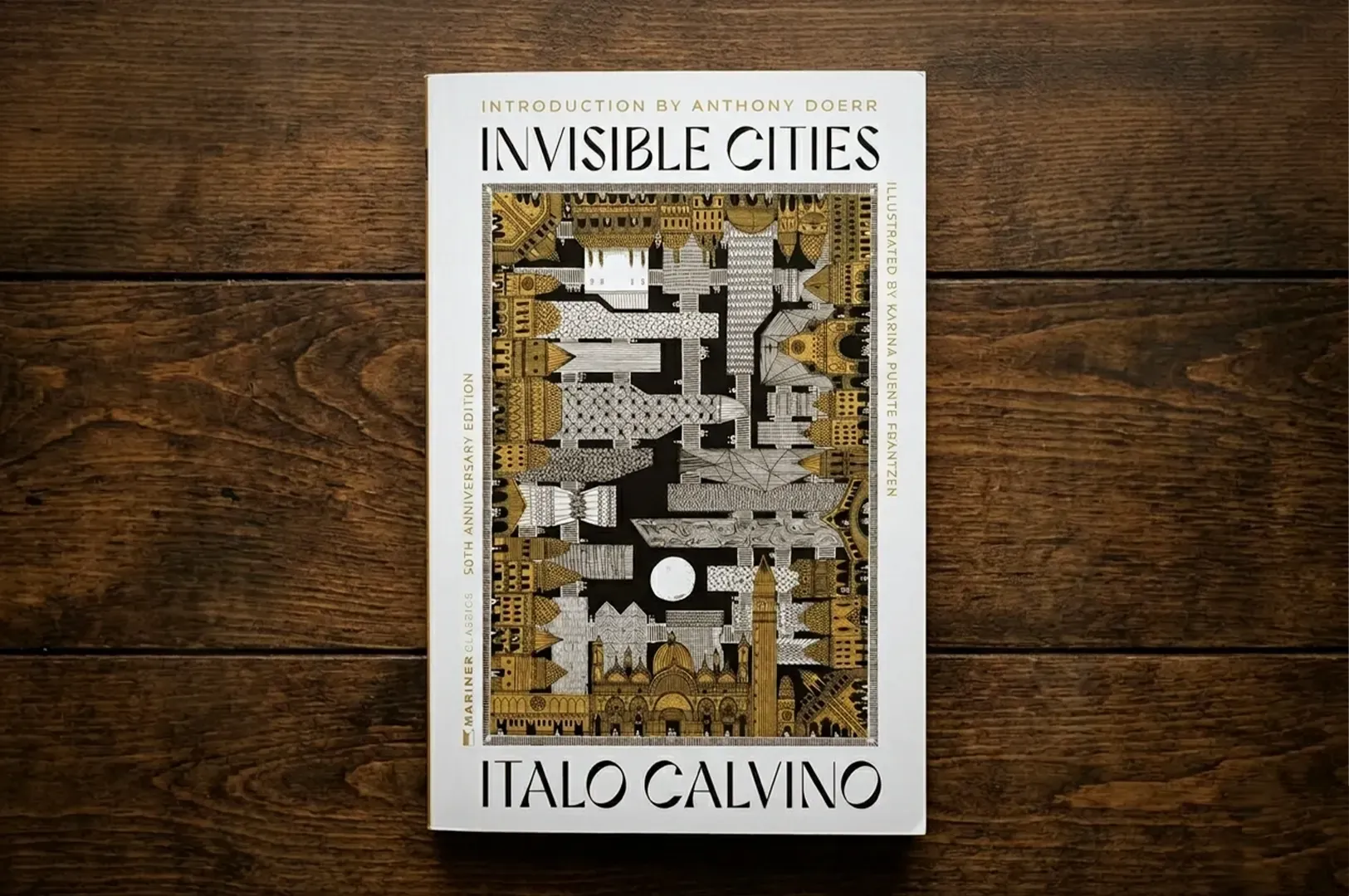 A flat-lay photograph of the 50th-anniversary edition of Invisible Cities by Italo Calvino, resting 