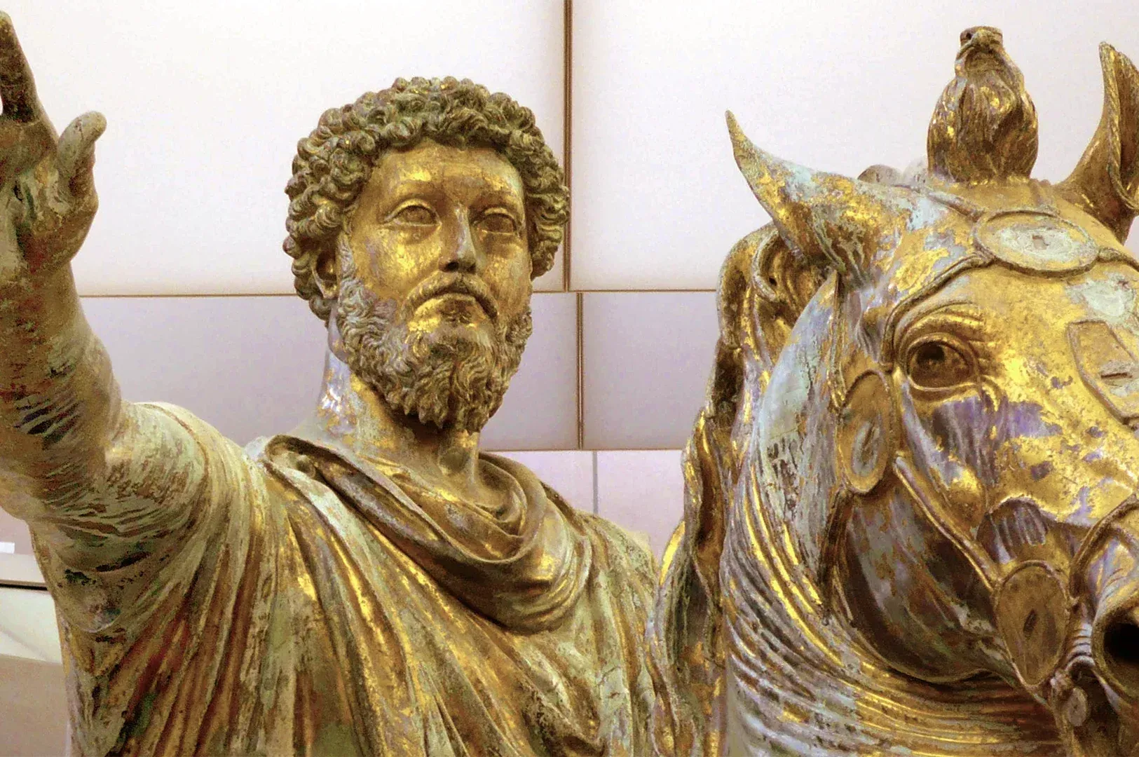 A gold statue of Marcus Aurelius, symbolizing the Stoic focus on personal control, quiet duty, and t