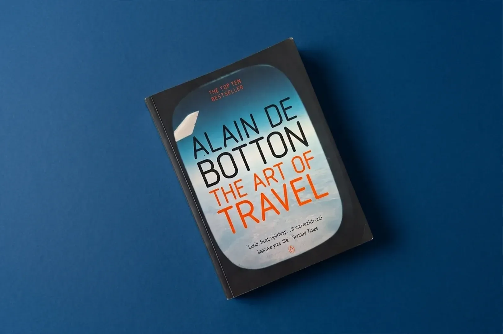 Front cover of The Art of Travel by Alain de Botton featuring an airplane window view, exploring how