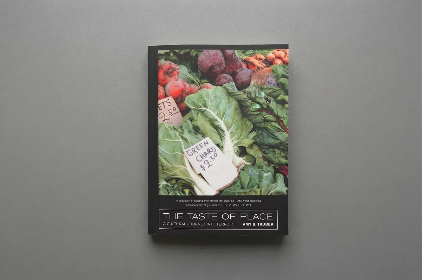 The book cover of The Taste of Place: A Cultural Journey Into Terroir by Amy B. Trubek, resting on a
