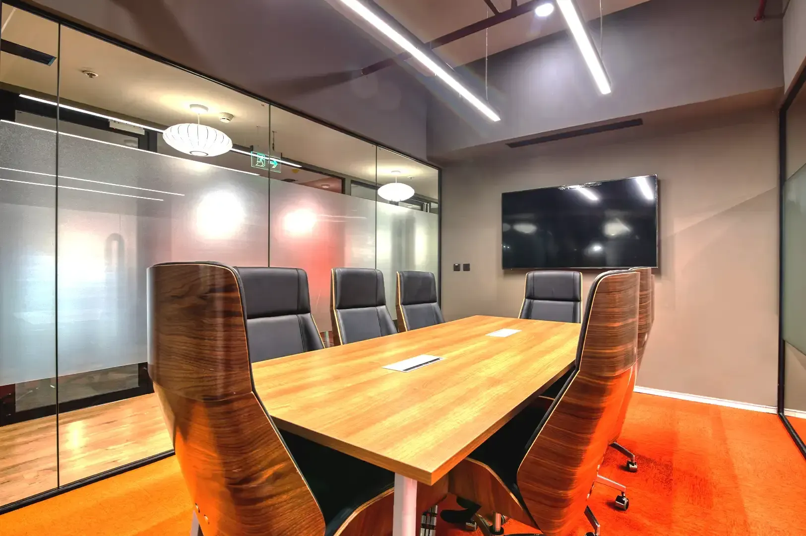 A modern, well-lit executive boardroom featuring a polished wooden conference table and sleek leather chairs, representing the structured environments where traditional business rules are thoughtfully evaluated and adapted.”