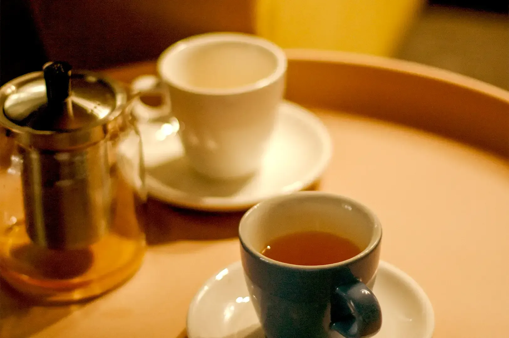A glass teapot and cups of tea resting on a tray, capturing a quiet, reflective pause that mirrors reputation as an asset earned in thoughtful, everyday moments.