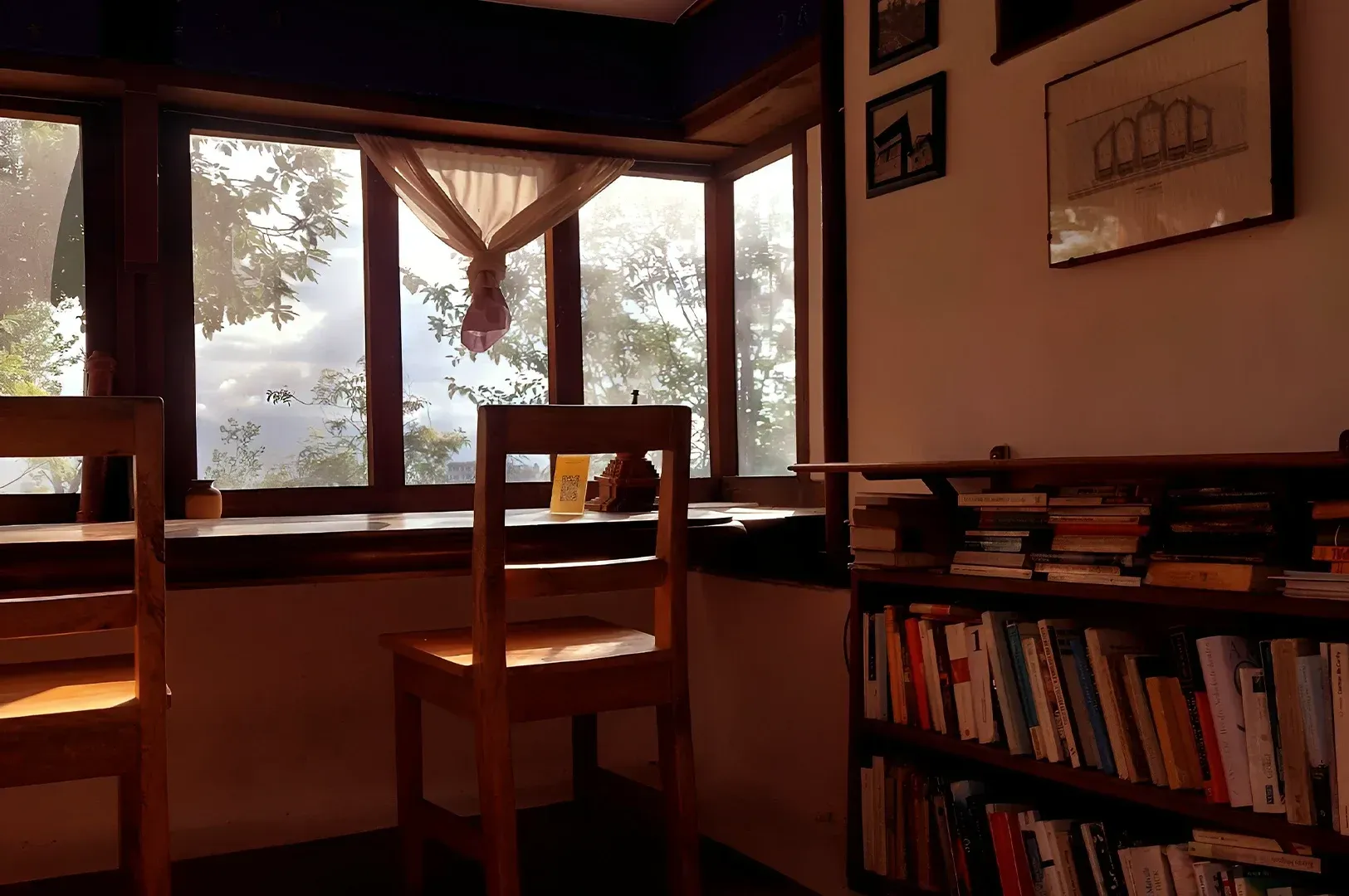 A tranquil morning view of a studio workspace with empty chairs facing a bright window, highlighting the importance of physical environment and solitude in creating conditions for deep, undisturbed creative work.