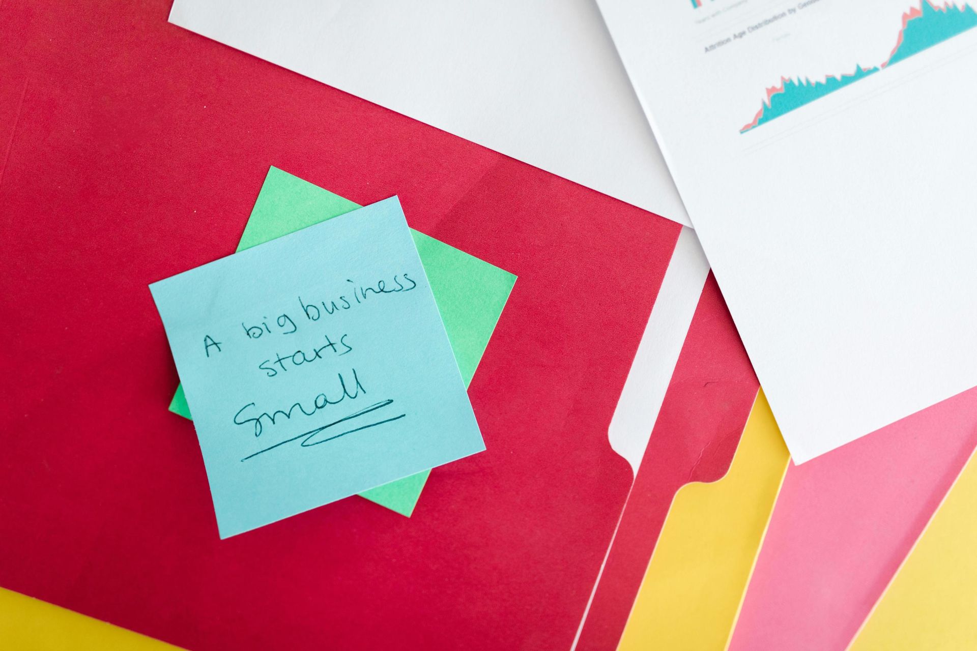 A blue sticky note featuring the handwritten motivational phrase