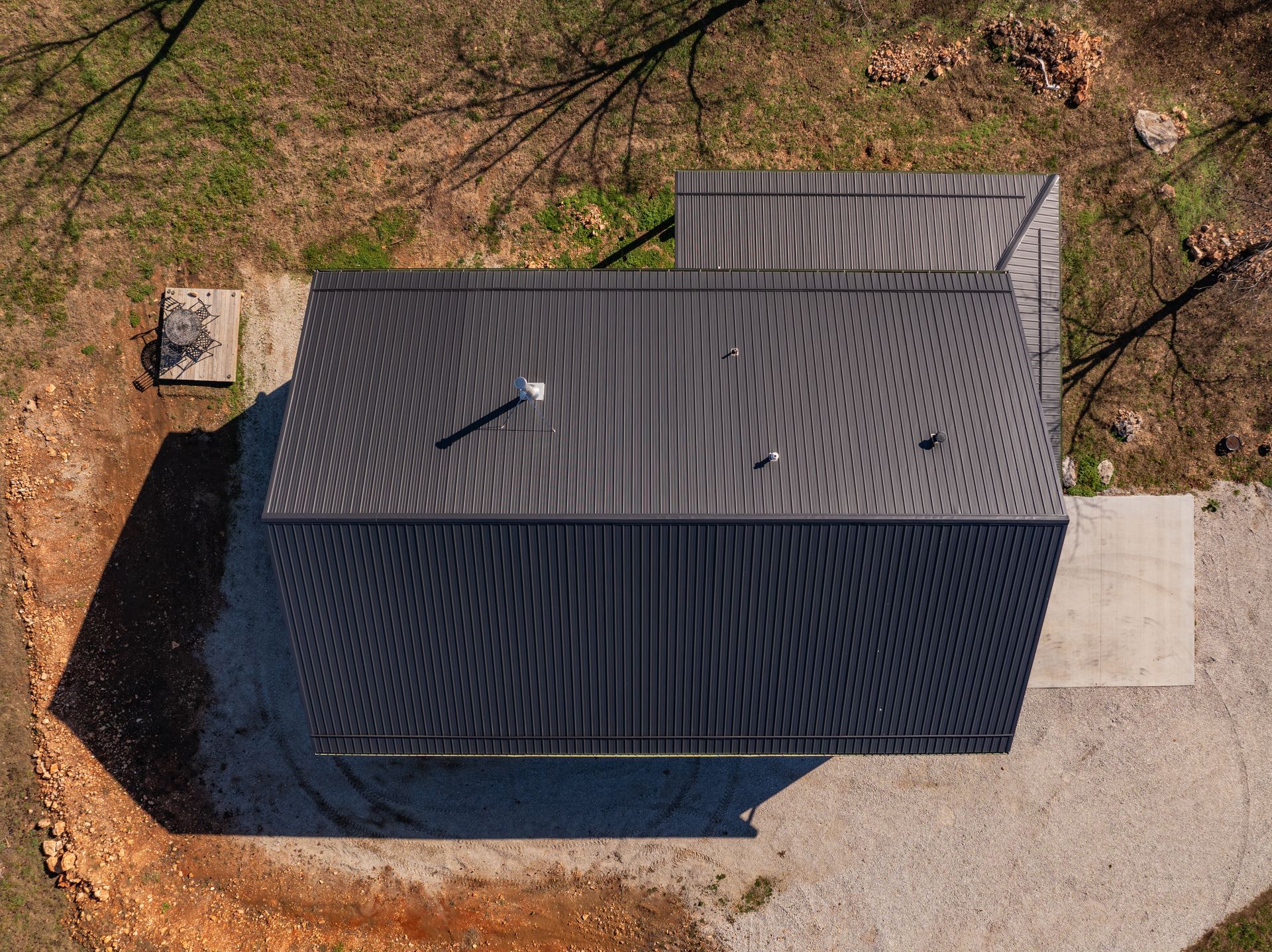 An aerial view of a black metal roof of a house.