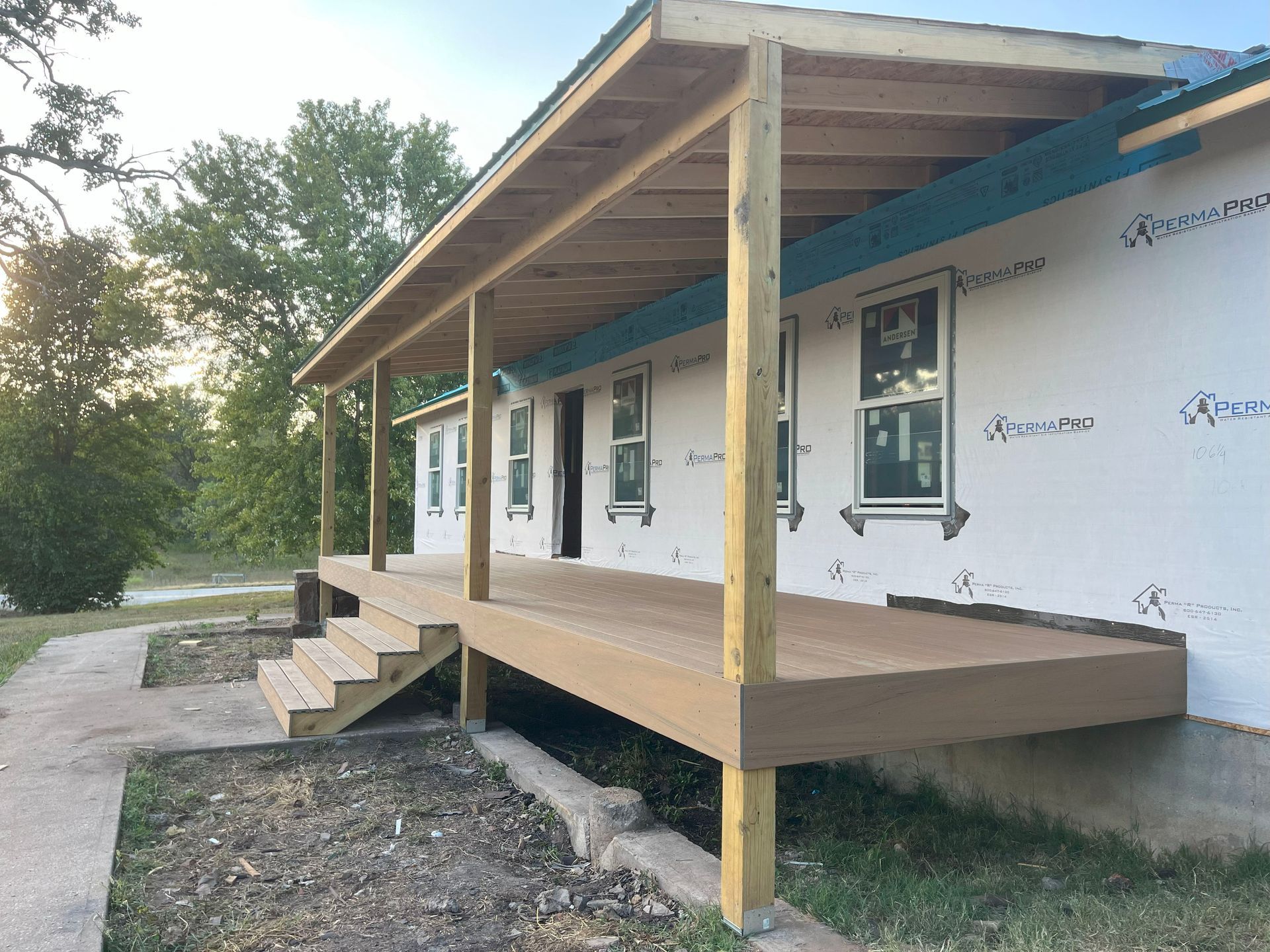 A house under construction with a porch and stairs
