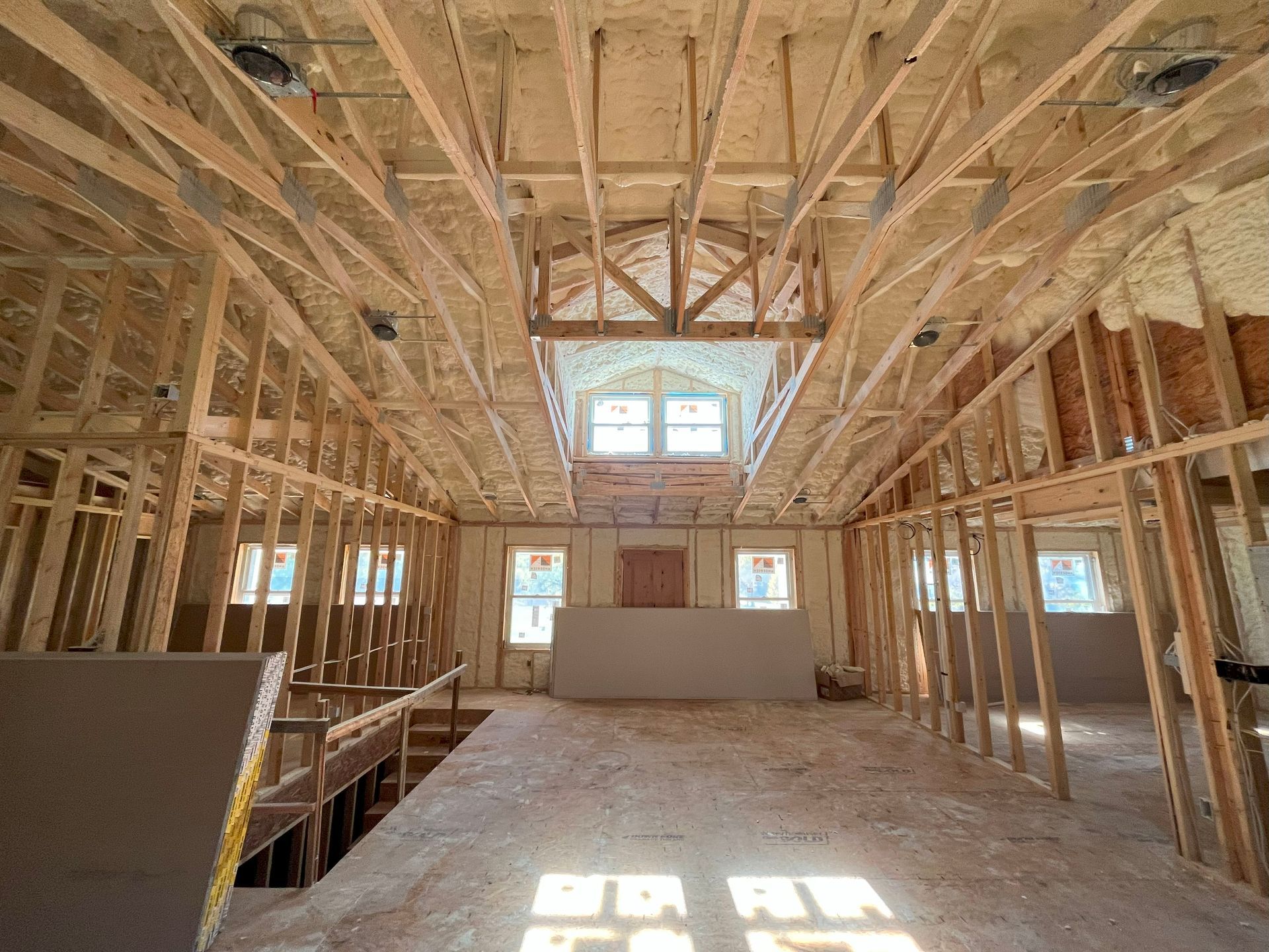 The inside of a building under construction with a skylight in the ceiling.